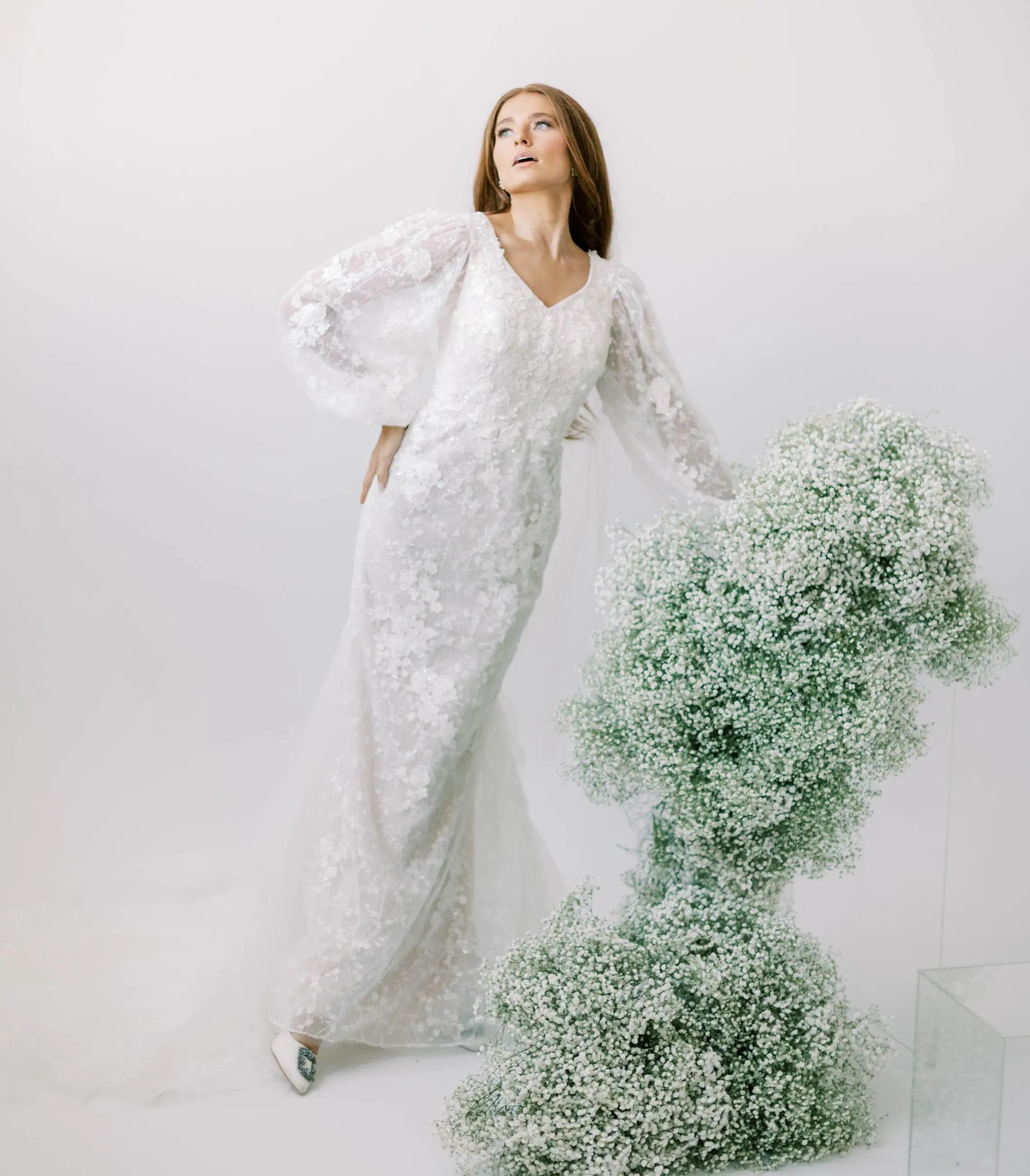 Model wearing a white bridal gown near the flowers